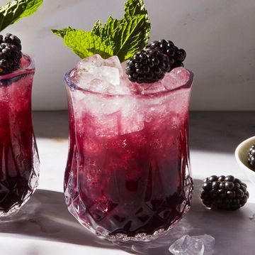 purple blackberry mint julep with crushed ice garnished with a blackberry and mint sprig