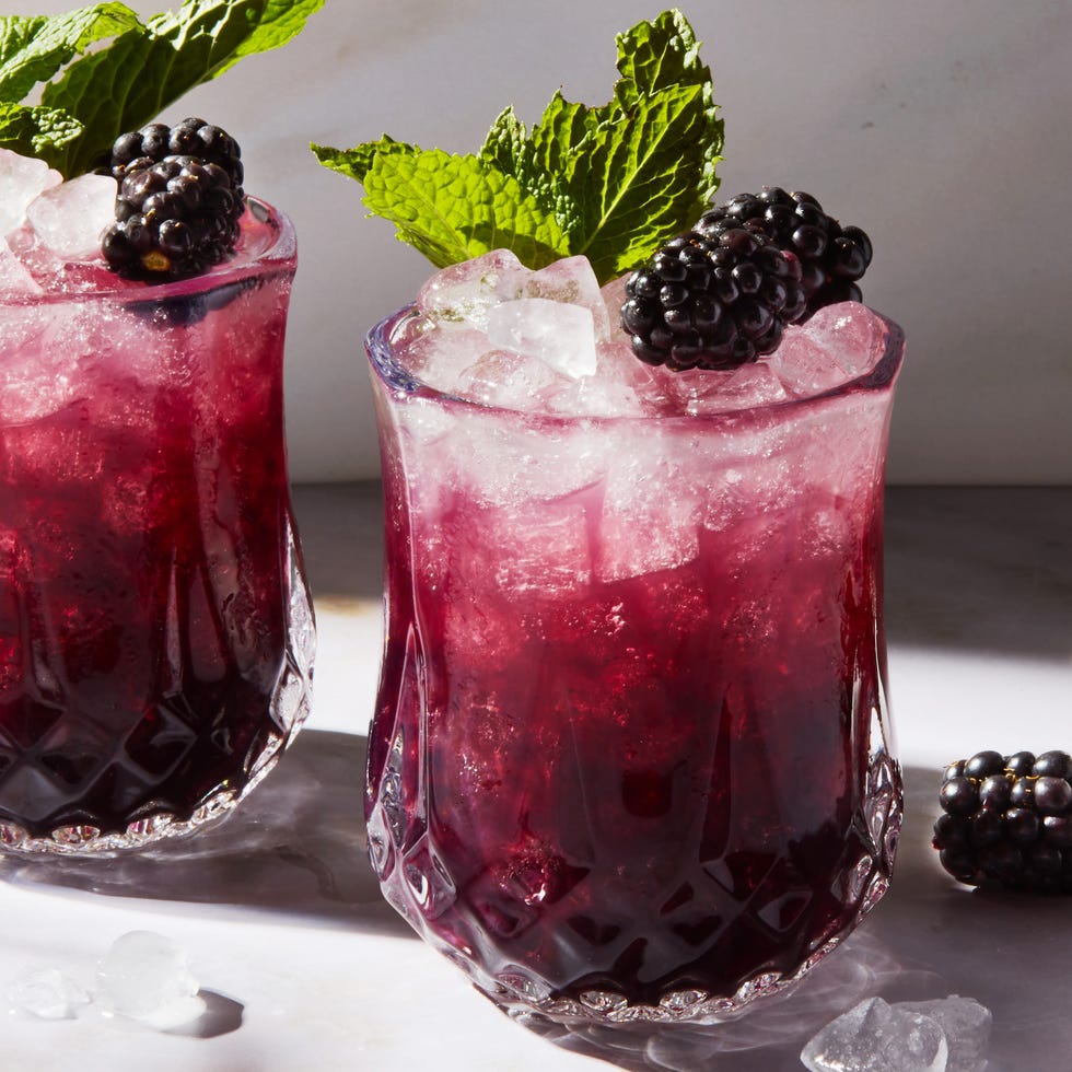 purple blackberry mint julep with crushed ice garnished with a blackberry and mint sprig