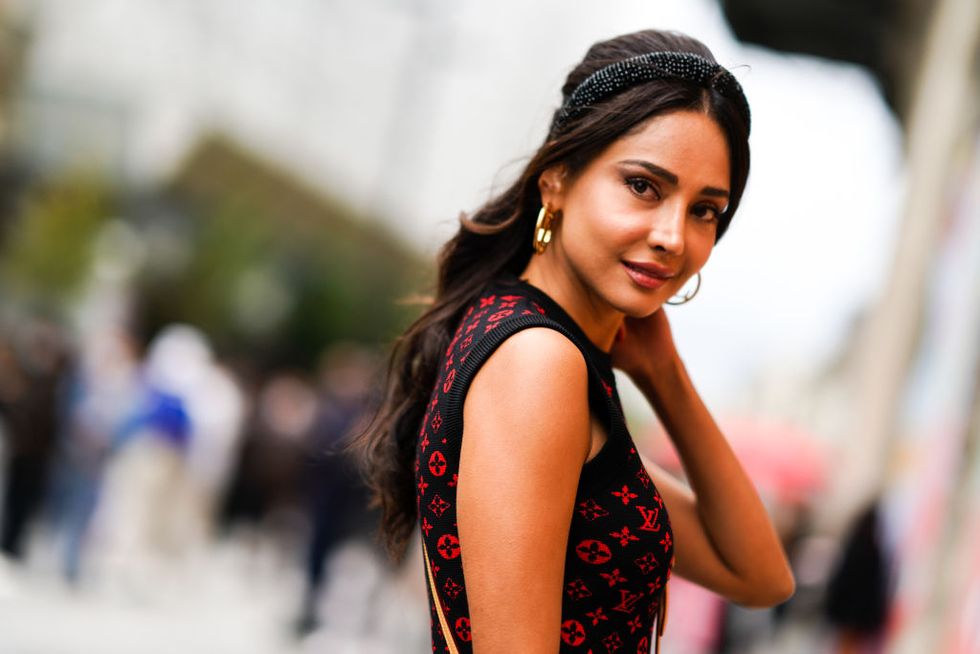 paris, france october 06 patricia gloria contreras wears earrings, a headband, a sleeveless black and red vuitton monogram print pullover,outside louis vuitton, during paris fashion week   womenswear spring summer 2021, on october 06, 2020 in paris, france photo by edward berthelotgetty images
