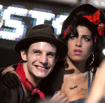 blake fielder civil smiling as he embraces a concerned looking amy winehouse
