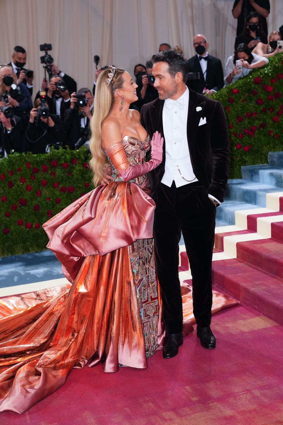 blake lively and husband ryan reynolds smile gazingly into each other's eye at the 2022 met gala celebrating "in america an anthology of fashion" arrivals