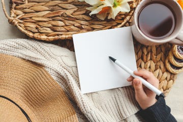 a person writing condolence messages in a card