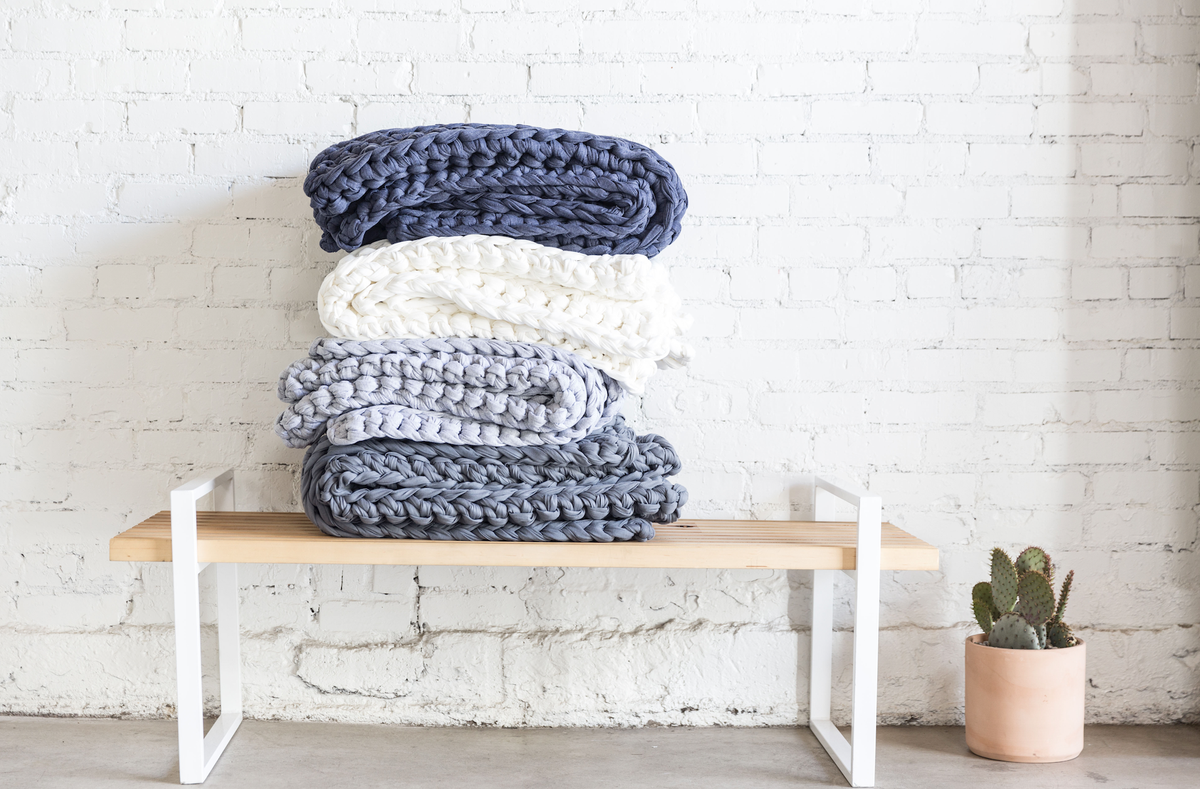 stack of blankets on bench