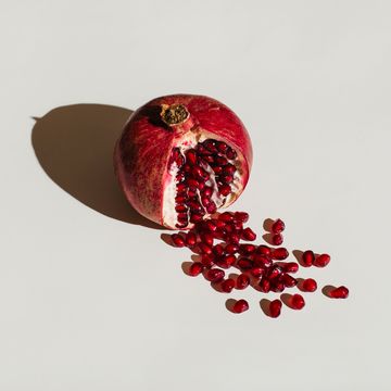 a cut pomegranate to with seeds spilling out to symbolise bleeding after sex