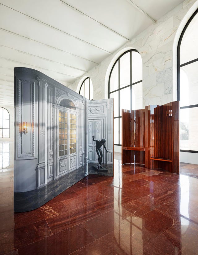 a room with a wood floor and a door with a window