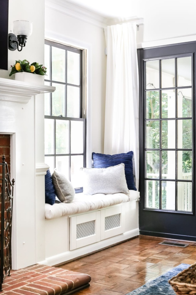 cozy window seat with decorative pillows in a bright room