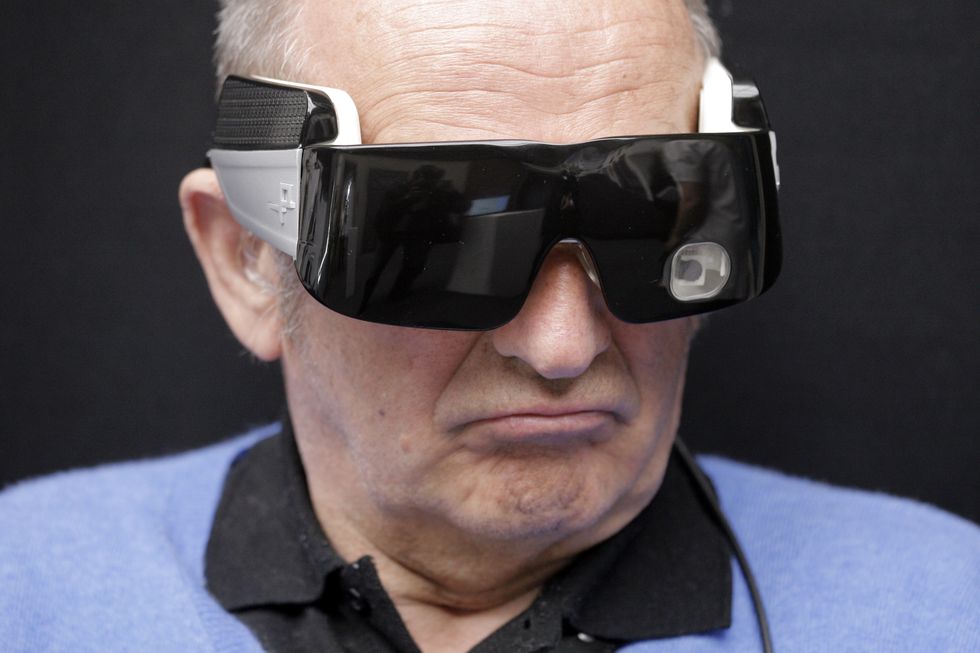 a blind patient wears an artificial retina at the quinze vingts national eye hospital in paris on april 22 2015 during a visit by the french minister for social affairs health and women's rights