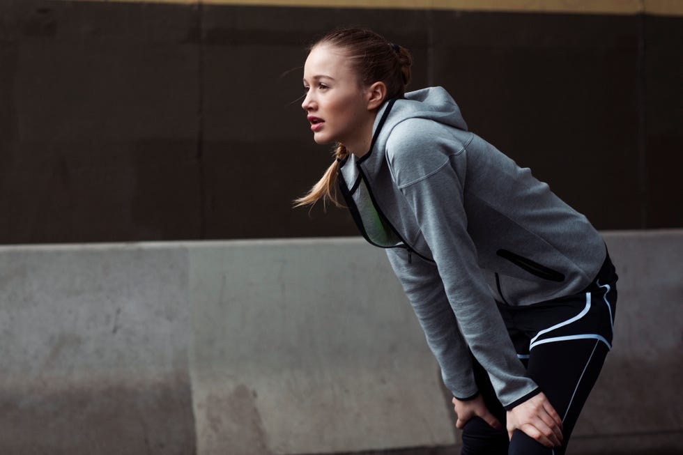 blonde woman catching her breath after running