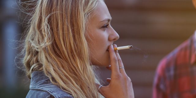 Blonde woman smoking cigarette
