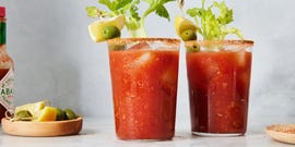 bloody mary garnished with lemon, celery, and olives