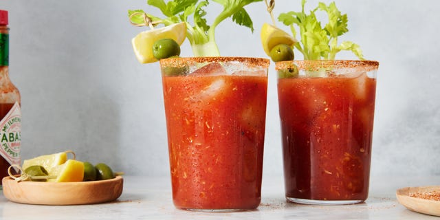 bloody mary garnished with lemon, celery, and olives