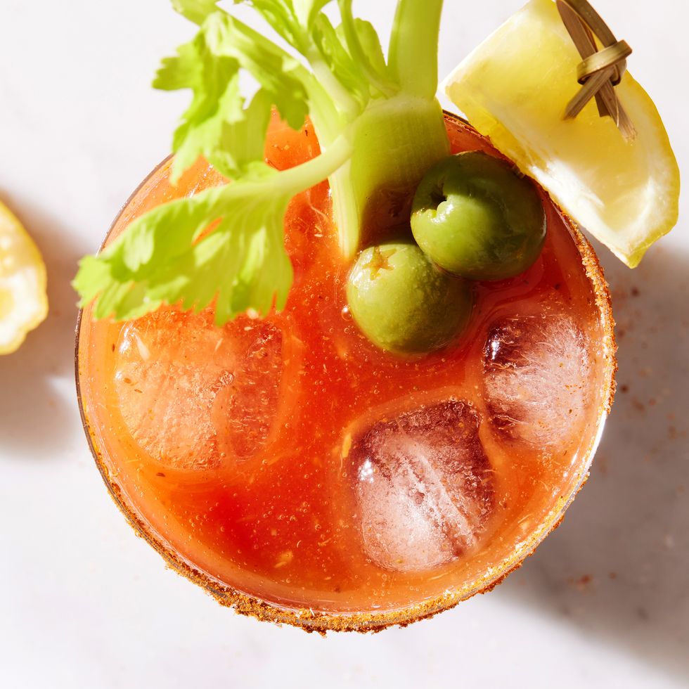 bloody mary garnished with lemon, celery, and olives