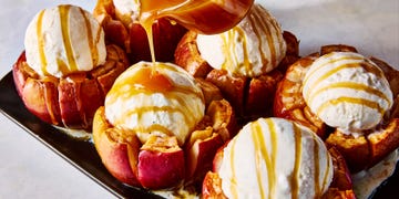 apples cut and topped with vanilla ice cream and caramel