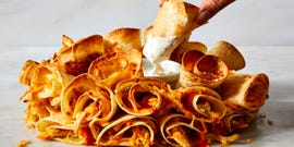 many quesadillas folded and placed into a ring shape that surrounds a cup of dip