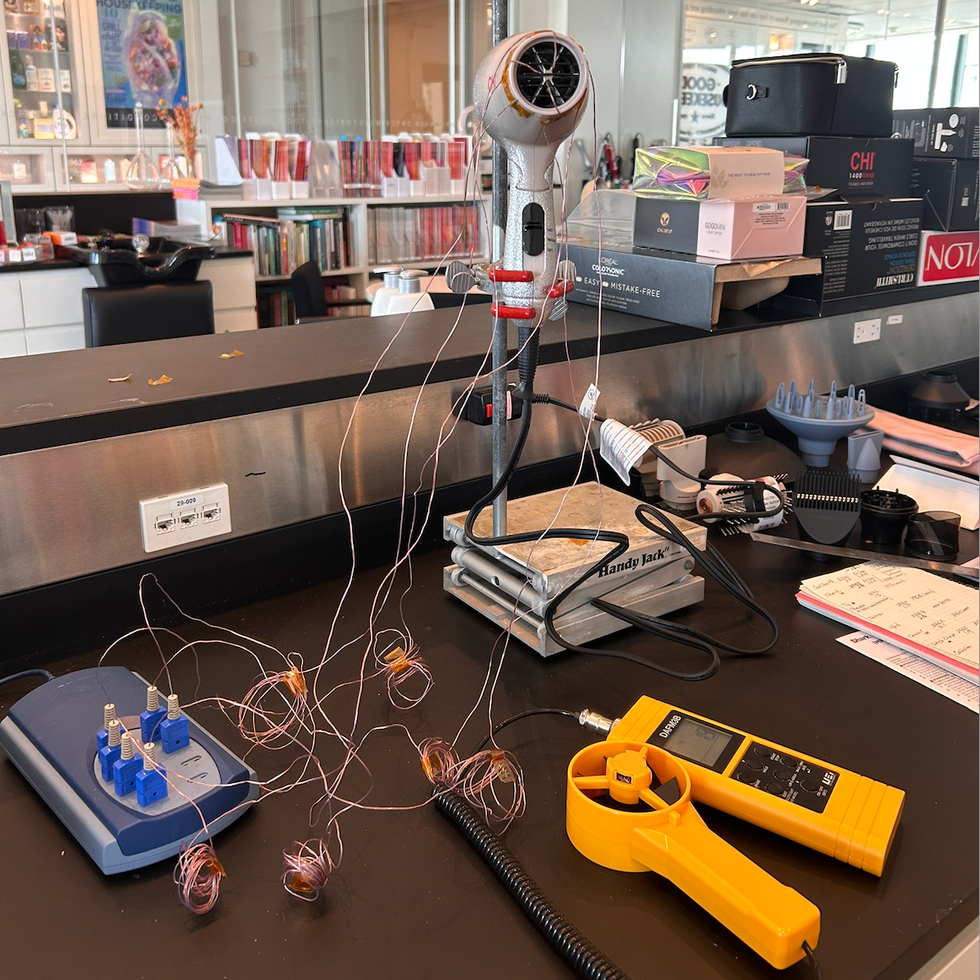 a photo of the a blowdryer being tested in the good housekeeping institute beauty lab