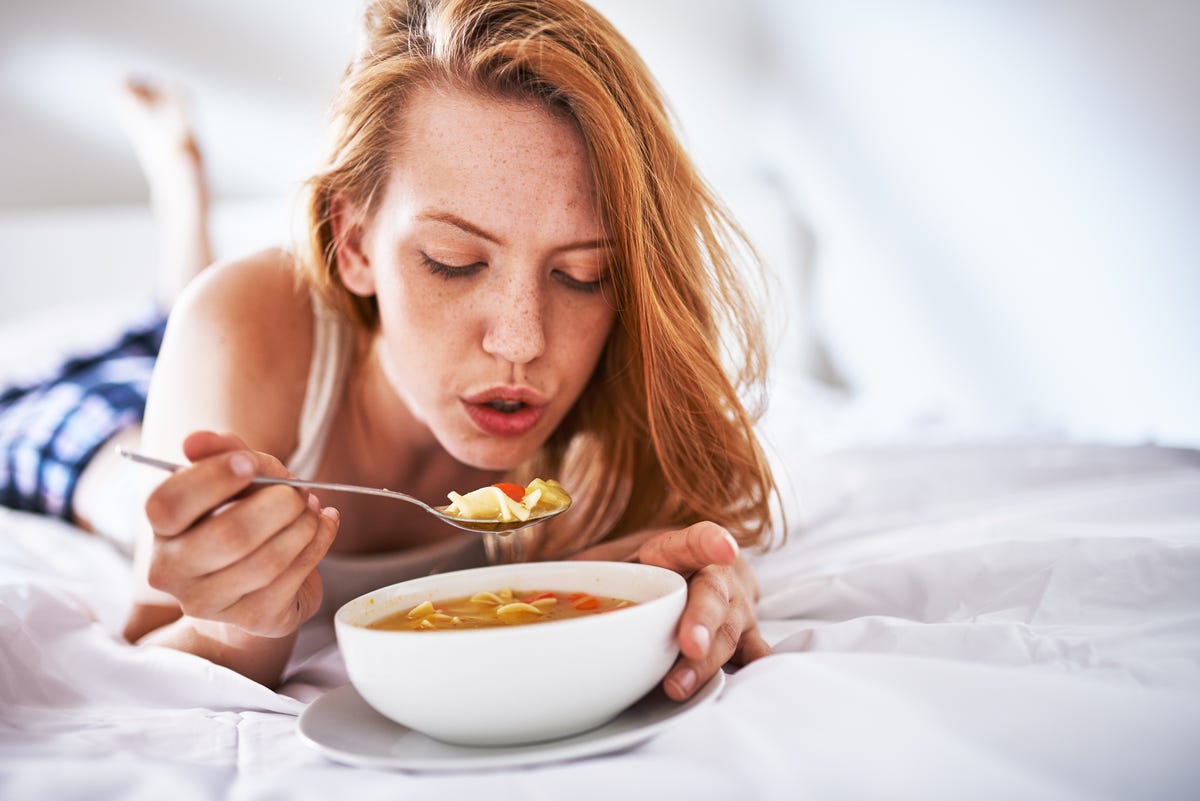 blowing on soup to cool it down in bed