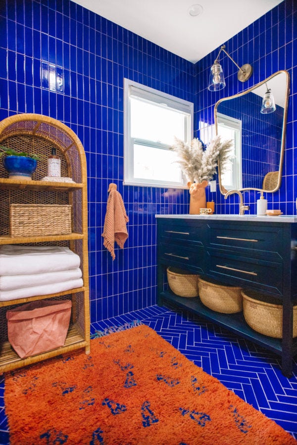 modern bathroom with blue tiled walls and a stylish vanity