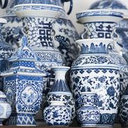 a collection of blue and white vases bottles and jars