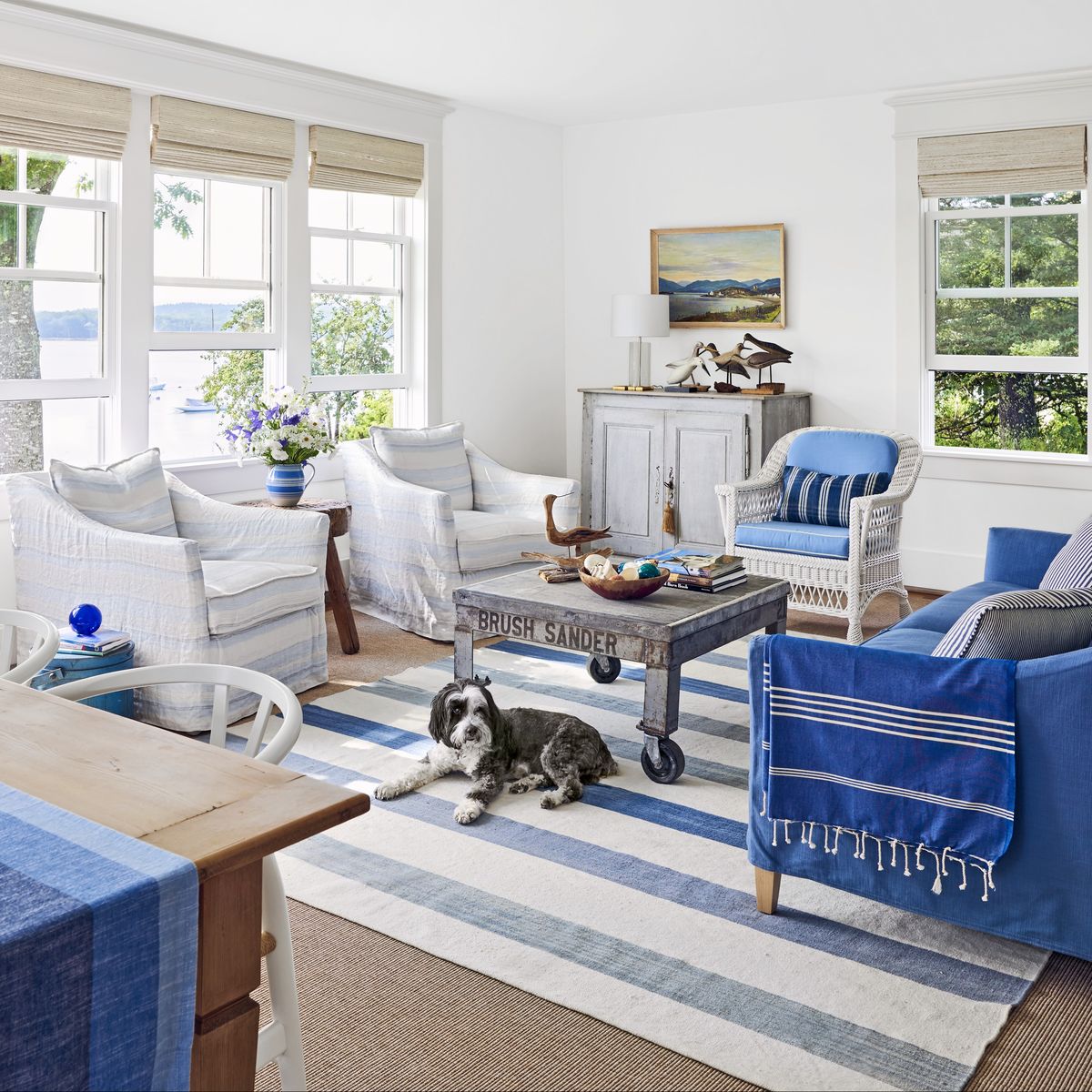 a blue and white living room in a coastal house