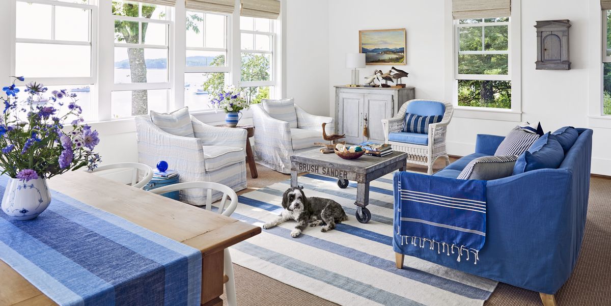 a blue and white living room in a coastal house