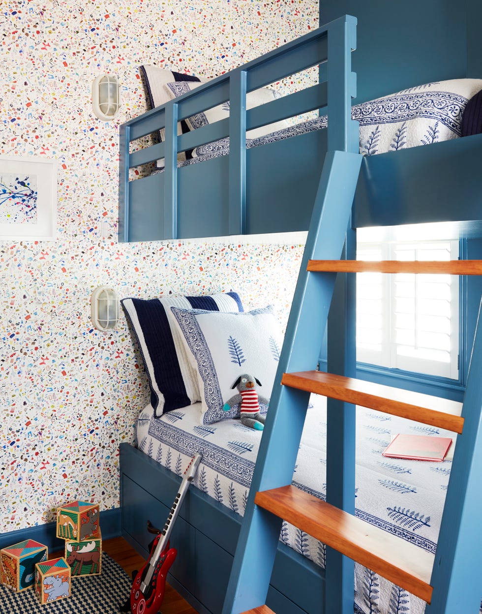 child's bedroom with blue bunk beds with split rail fence style railing