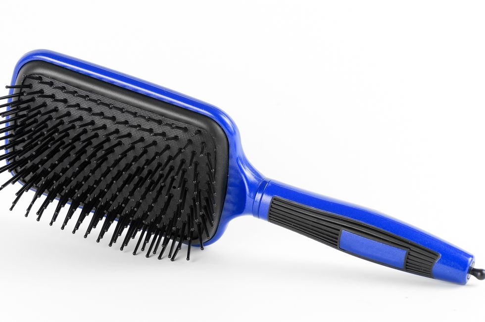 blue comb the hair on a white background