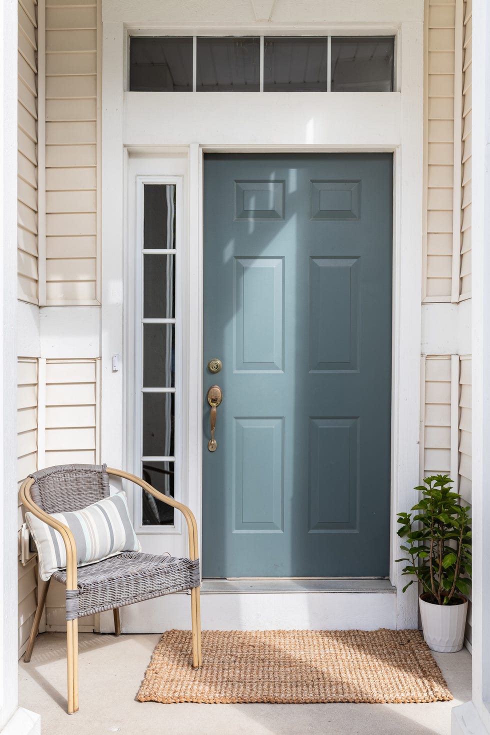a blue front door detail with a small porch
