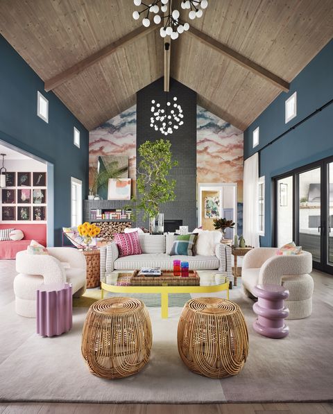 living room with custom wallcovering mural created by munroe 

coffee table croft house 
rattan stools article 
wallcovering phillip jeffries 
chandeliers circa lighting 
paint farrow  ball