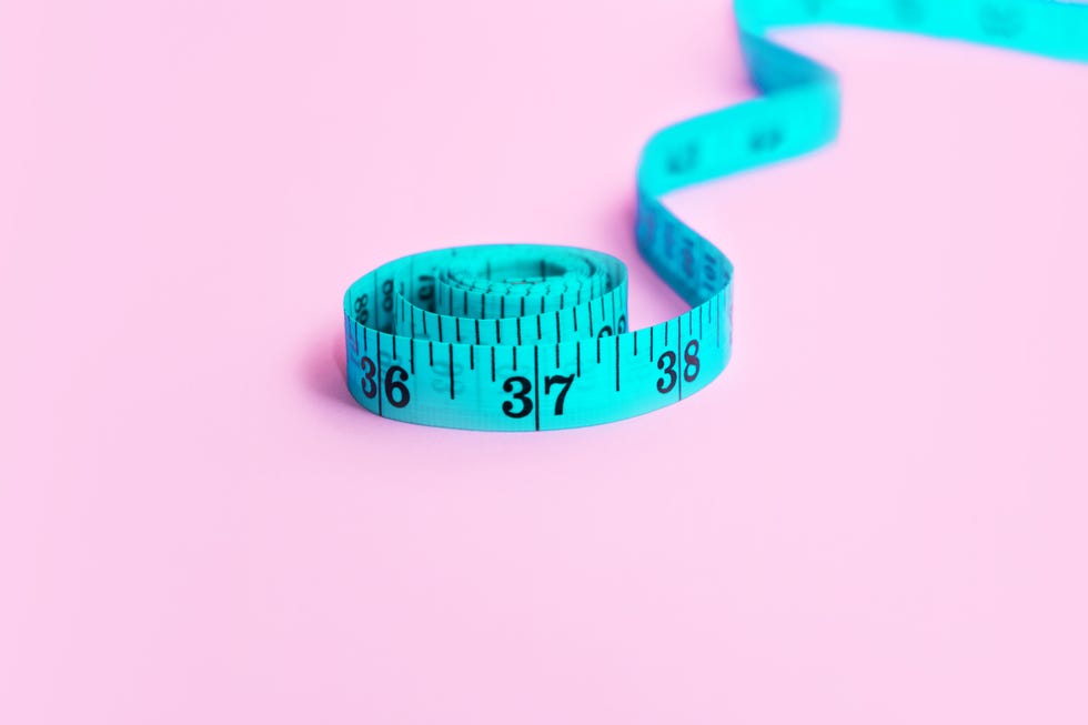 blue measuring tape on pink background