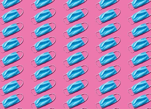 blue medical face mask to avoid contagious diseases pattern on pink background