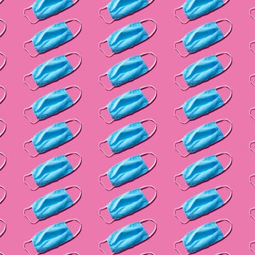 Blue medical face mask to avoid contagious diseases pattern on pink background blue medical face mask to avoid contagious diseases pattern on pink background