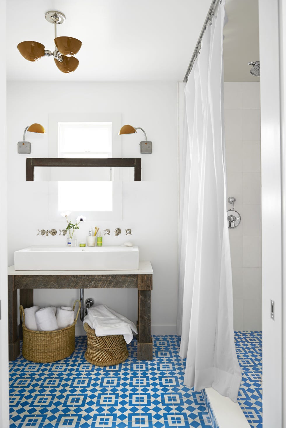 blue tiled bathroom with storage baskets