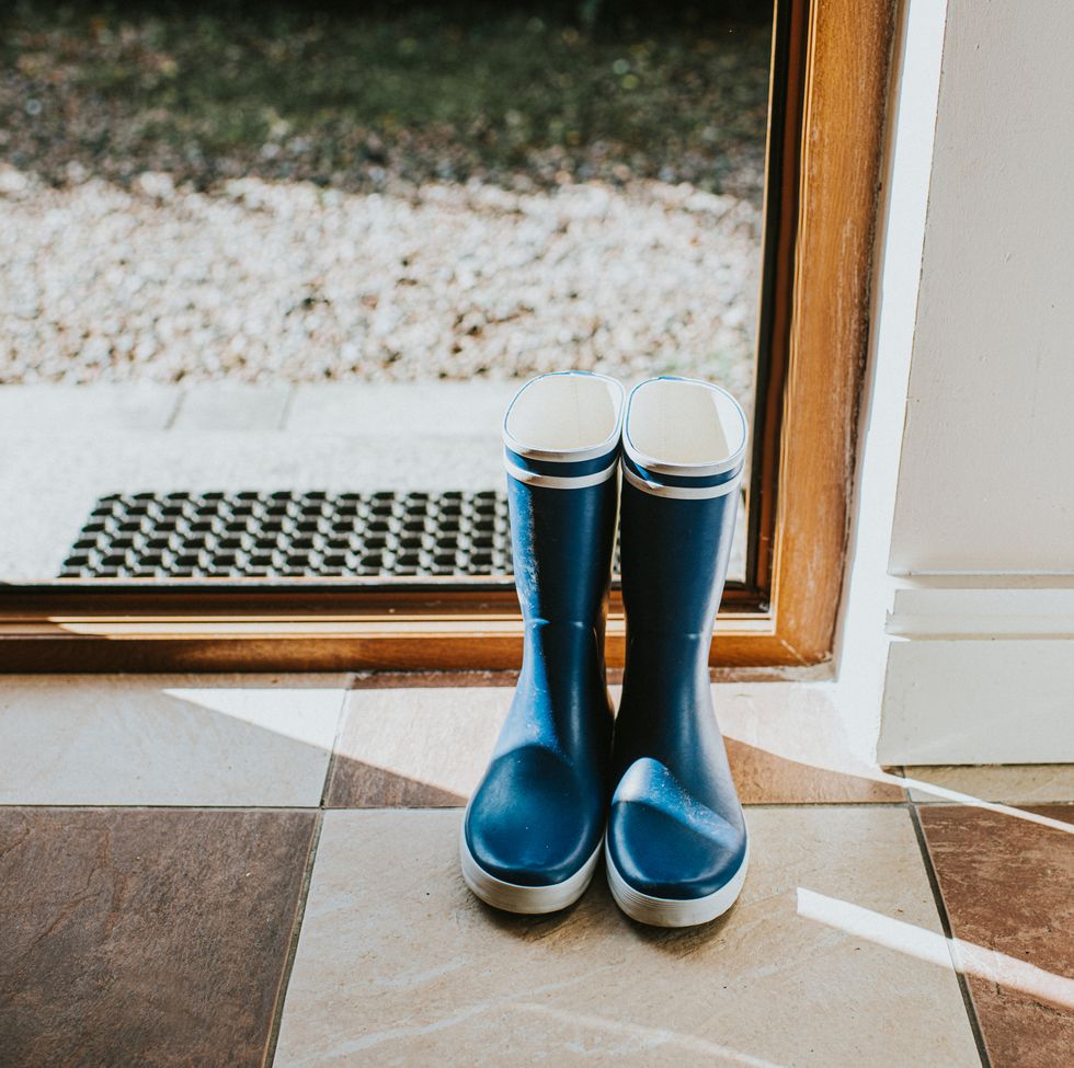 blue welly boots sitting by an open back door
