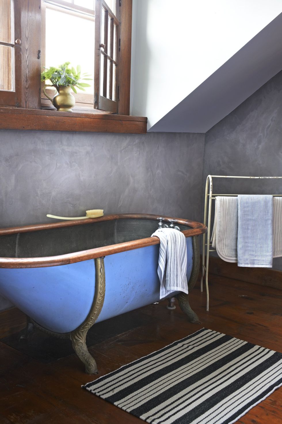 https://hips.hearstapps.com/hmg-prod/images/blue-wood-rimmed-metal-claw-foot-tub-1557431845.jpg?crop=0.9987228607918264xw:1xh;center,top&resize=980:*