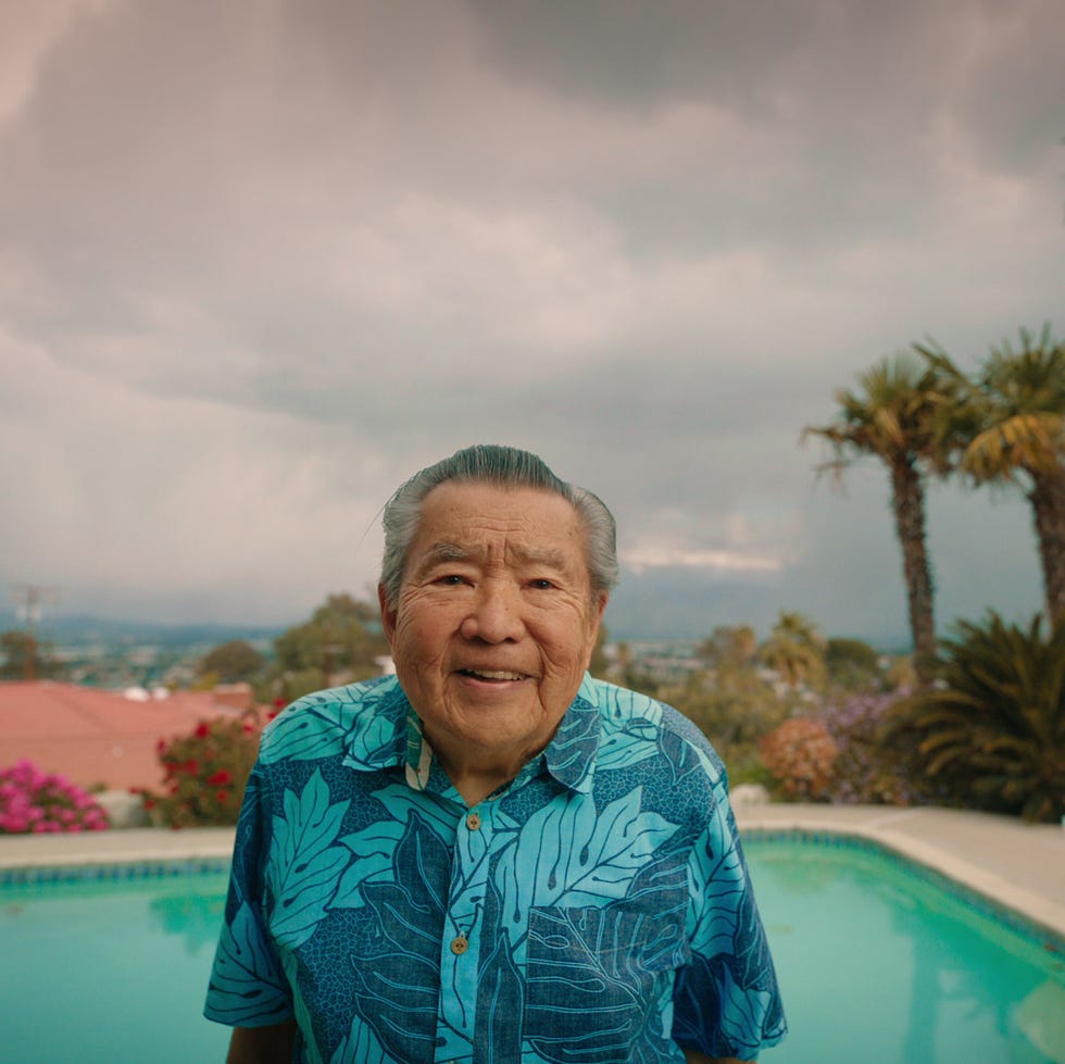 a man standing by a pool