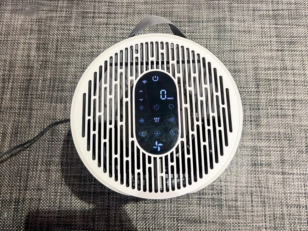 Air purifier with control panel and display showing air quality indicators Air purifier with control panel and display showing air quality indicators