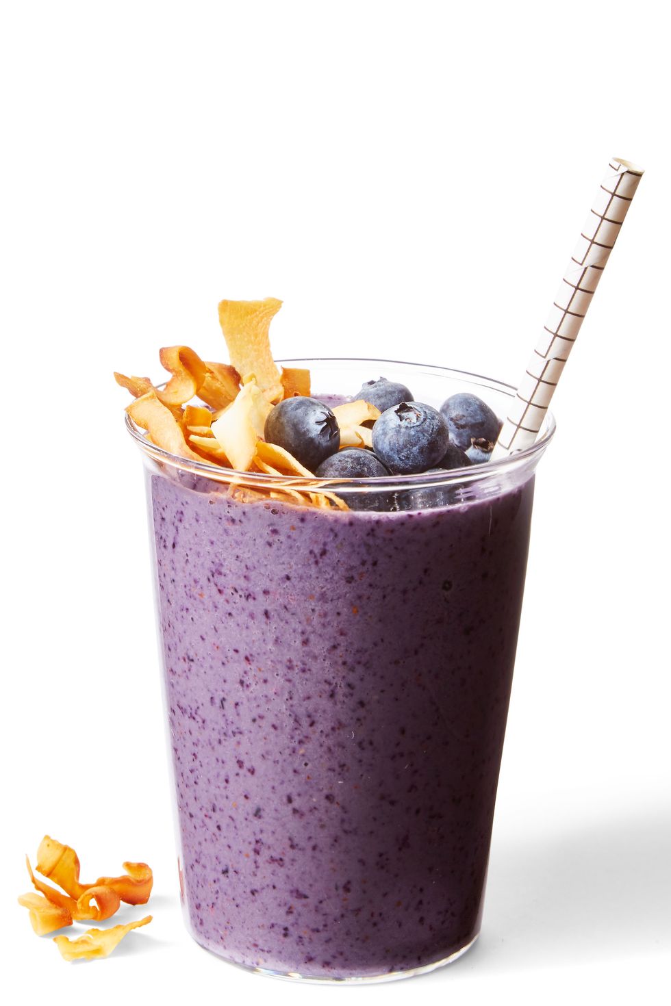 a purple blueberry banana nut smoothie with toasted coconut and blueberries on top