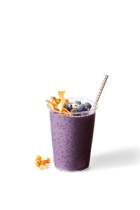 a purple blueberry banana nut smoothie with toasted coconut and blueberries on top