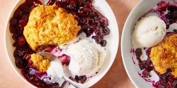 blueberries in a pan topped with biscuits
