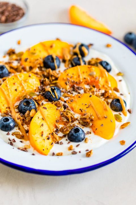 peaches in a bowl with blueberries on yogurt