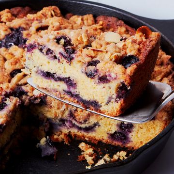 blueberry cake in a skillet topped with a crumble