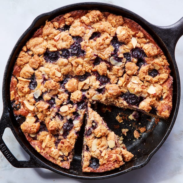 blueberry cake in a skillet topped with a crumble