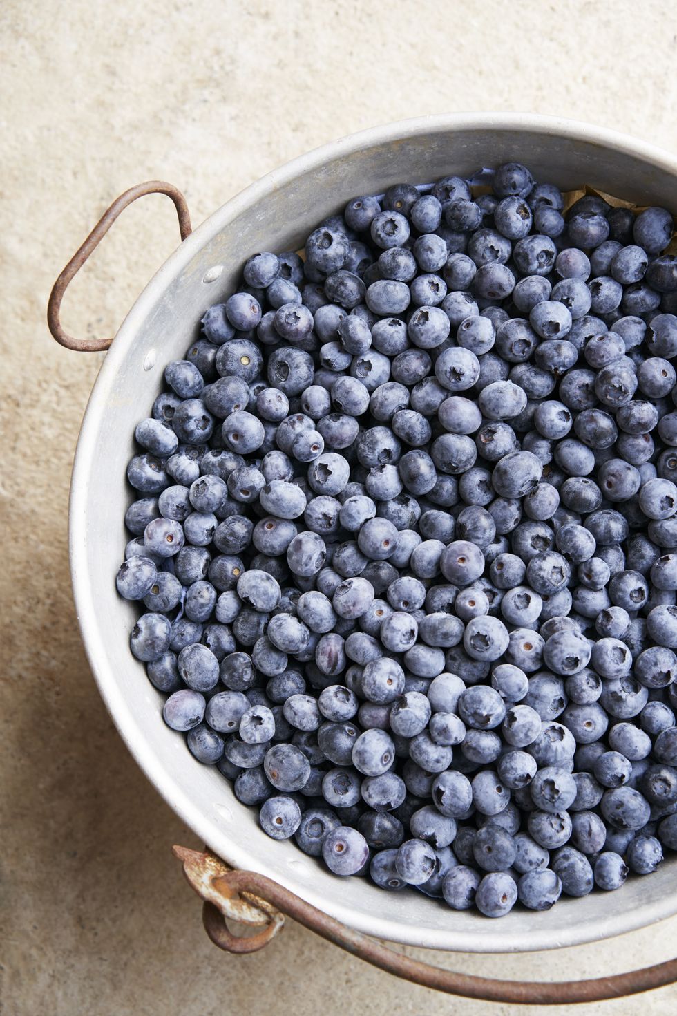 close up on blueberries in metal container