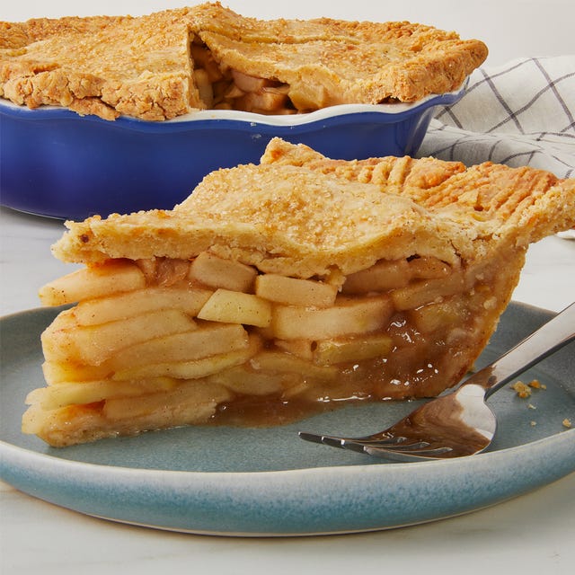 slice of apple pie served on a plate with a fork beside it