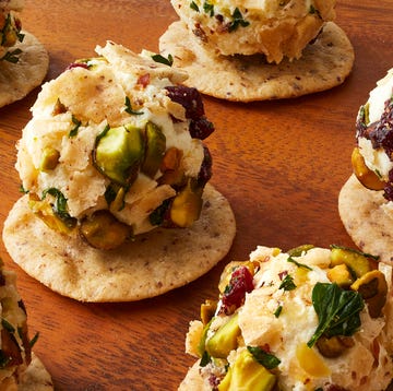 cheese balls topped with nuts and herbs served on crackers cheese balls topped with nuts and herbs served on crackers