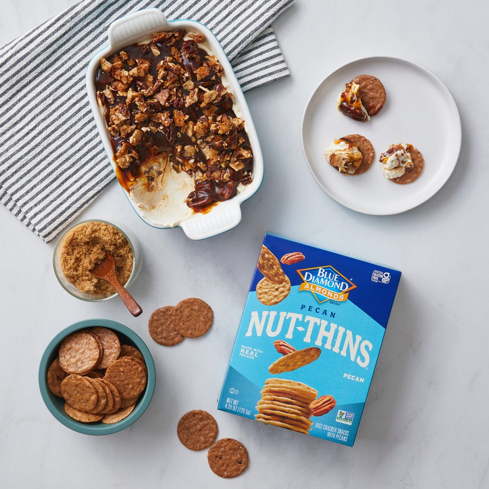 a spread of snacks including a layered dessert nutthins crackers and brown sugar a spread of snacks including a layered dessert nutthins crackers and brown sugar