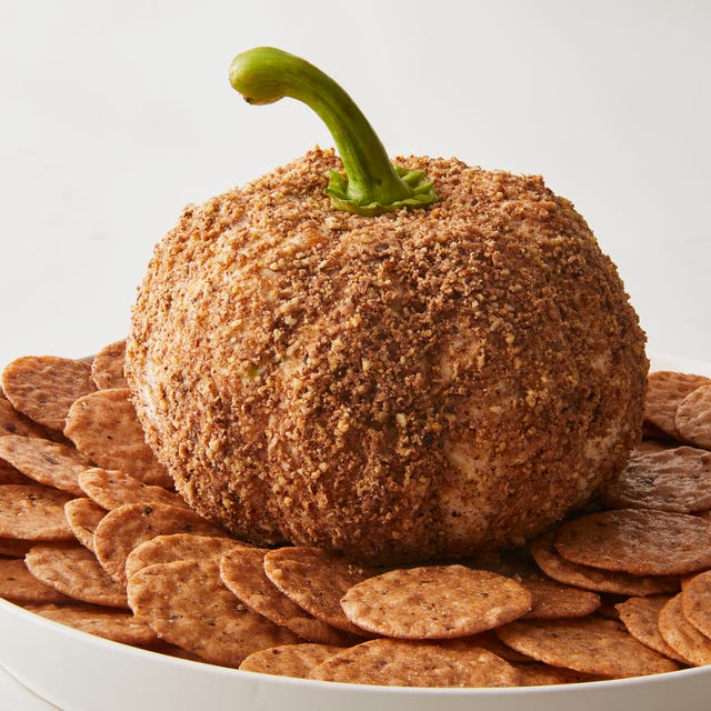 cheese ball shaped like a pumpkin surrounded by crackers