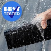 water splashing waterproof speaker and speaker on sand at beach