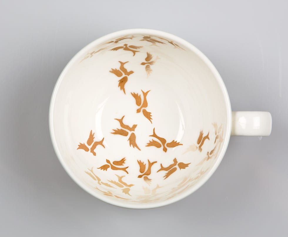 ceramic cup with an intricate bird design on the interior surface