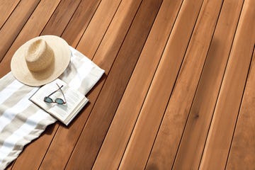 a hat and a book on a deck